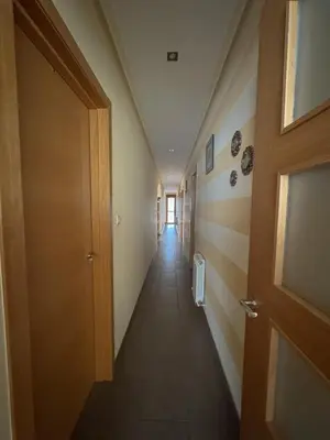 a hallway with a door and a long corridor at Casa Idalia in Ourense