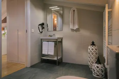 a bathroom with a sink and a mirror at Os Sobriños Do Pai in Santiago de Compostela