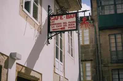 a cafe bar sign on the side of a building at Os Sobriños Do Pai in Santiago de Compostela