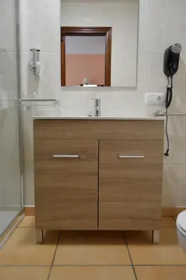 a bathroom with a sink and a mirror at Hotel Restaurante Val in Antas de Ulla