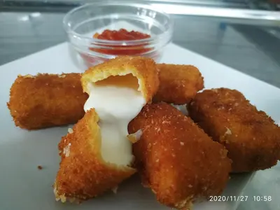 a white plate with some fried food on it at Hotel Restaurante Val in Antas de Ulla