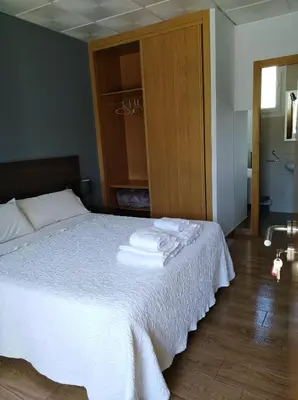 a bedroom with a bed with towels on it at O Cruceiro in Palas de Rei