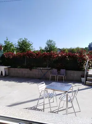 two chairs and a table on a patio at O Cruceiro in Palas de Rei