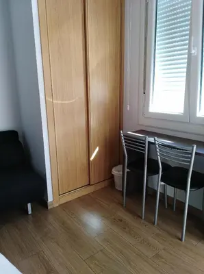 a room with a table and chairs and a cabinet at O Cruceiro in Palas de Rei