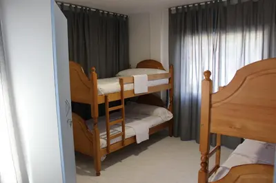 a bedroom with two bunk beds and a window at A Senda in Caldas de Reis