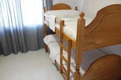 two bunk beds in a room with a window at A Senda in Caldas de Reis