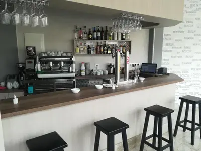 a bar with black stools in a kitchen at A Senda in Caldas de Reis