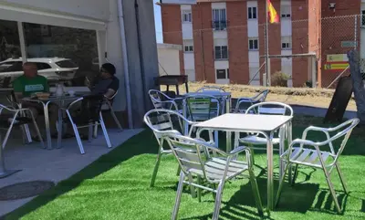 a group of chairs and tables on a lawn at A Senda in Caldas de Reis