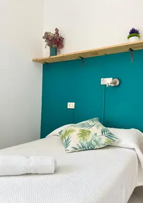 a bedroom with a blue wall and a bed with a pillow at A Senda in Caldas de Reis