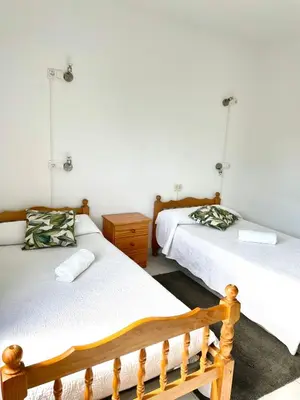 a bedroom with two beds and a wooden bed frame at A Senda in Caldas de Reis