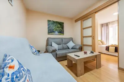 a room with a bed and a chair and a table at Apartamento Centro Santiago in Santiago de Compostela