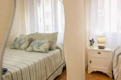 a bedroom with a bed with pillows and a window at Apartamento Centro Santiago in Santiago de Compostela