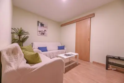 a living room with a couch and a table at Apartamento Centro Santiago in Santiago de Compostela