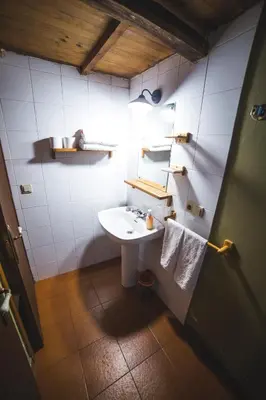 a bathroom with a sink and a mirror at Caserío da Castiñeira in Sas do Monte