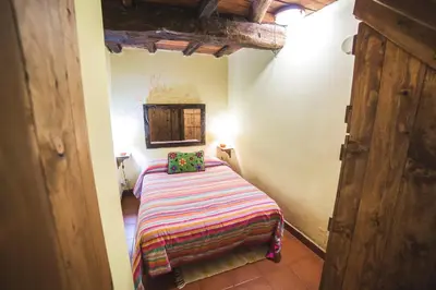 a small bedroom with a bed in a room at Caserío da Castiñeira in Sas do Monte