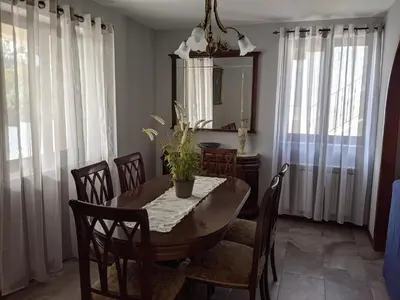 a dining room with a table and chairs and a mirror at Casa Cabanas in Cabañas