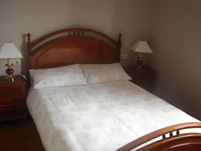 a bedroom with a large bed with two night stands at Casa Cabanas in Cabañas