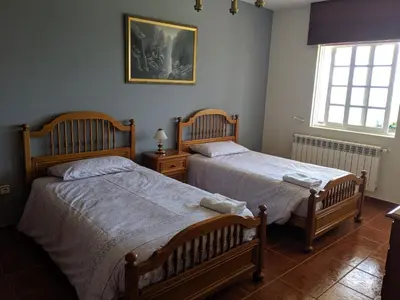 a bedroom with two beds and a window at Casa Cabanas in Cabañas