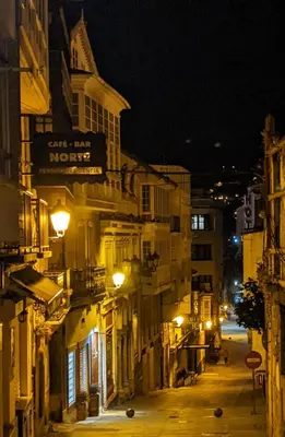 a city street at night with buildings and lights at Casa Cabanas in Cabañas