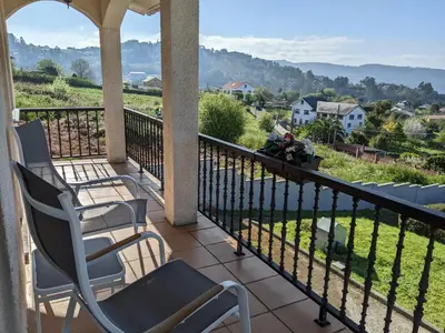 a balcony with chairs and a view of a valley at Casa Cabanas in Cabañas