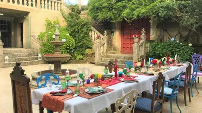a long table with white table cloth and candles on it at Casa Grande de Soutullo in Coles