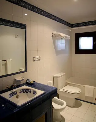a bathroom with a sink and a toilet and a tub at Casa Grande de Soutullo in Coles