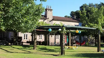 a garden with a gazebo in front of a building at Casa Grande de Soutullo in Coles