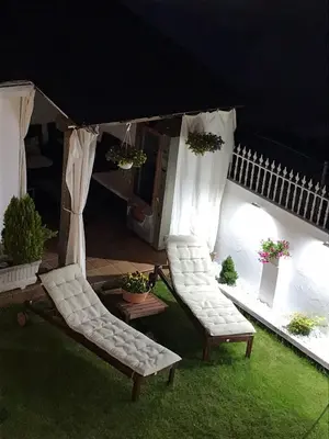 two chairs and a gazebo in a yard at PortoSantiago in Portomarin
