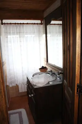 a bathroom with a sink and a window at Casa Samuel in Navia