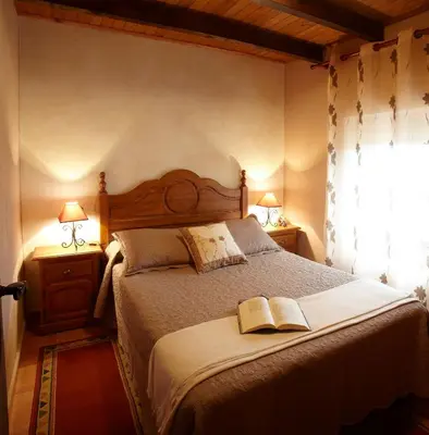 a bedroom with a bed with two books on it at Casa Samuel in Navia