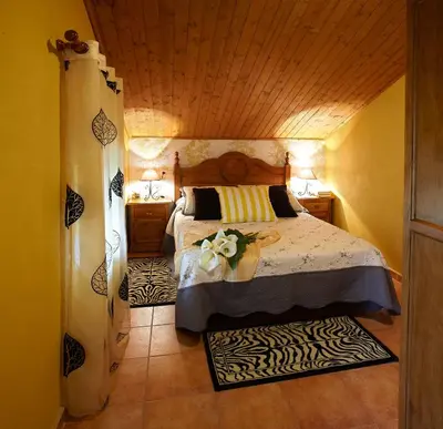 a bedroom with a bed with a flower on it at Casa Samuel in Navia
