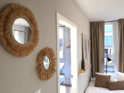 two mirrors on the wall of a bedroom at Joya en Orense Centro in Ourense