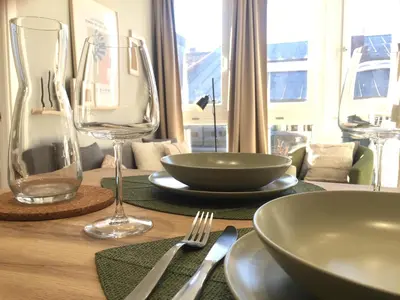 a table with plates and glasses on top of it at Joya en Orense Centro in Ourense