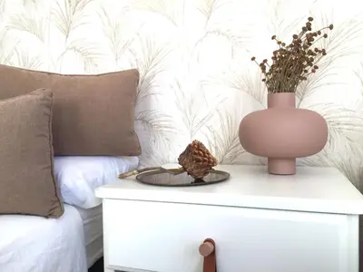 a bedroom with a bed and a table with a vase on it at Joya en Orense Centro in Ourense