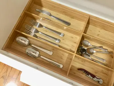 a wooden drawer with silver utensils in it at Joya en Orense Centro in Ourense