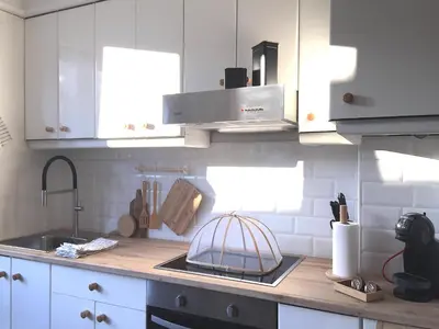 a kitchen with white cabinets and a sink at Joya en Orense Centro in Ourense