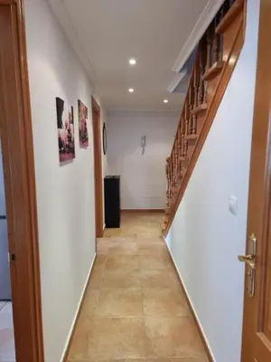 a hallway with stairs in a house at Dúplex 4 dormitorios en Playa Rapadoira in Foz