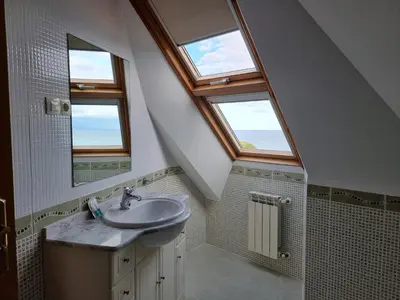 a bathroom with a sink and two windows at Dúplex 4 dormitorios en Playa Rapadoira in Foz