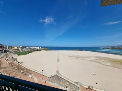a view of a beach from a balcony at Dúplex 4 dormitorios en Playa Rapadoira in Foz