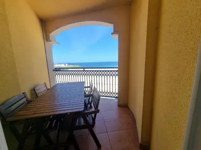 a dining room table with a view of the ocean at Dúplex 4 dormitorios en Playa Rapadoira in Foz