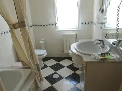 a bathroom with a sink and a tub and a toilet at Casa BRAIS in Barreiros