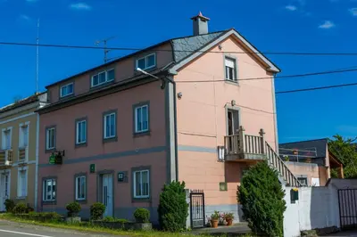 a large pink building on the side of a street at Casa BRAIS in Barreiros
