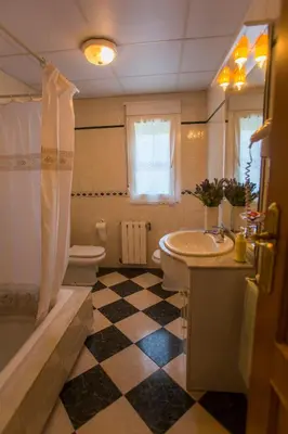 a bathroom with a black and white checkered floor at Casa BRAIS in Barreiros