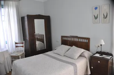 a bedroom with a bed and a large mirror at Alvarella in Villarmayor