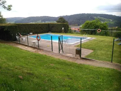 a swimming pool in a yard with a fence at Alvarella in Villarmayor