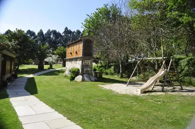 a park with a playground with a slide at Alvarella in Villarmayor