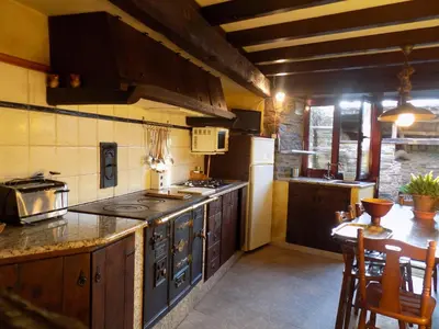 a kitchen with a stove and a counter top at Vivienda Vacacional Bioxana in Molejón