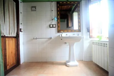 a bathroom with a sink and a mirror at Vivienda Vacacional Bioxana in Molejón