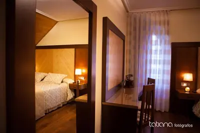 a bedroom with a bed and a large mirror at Hotel Restaurante La Casilla in Cangas del Narcea