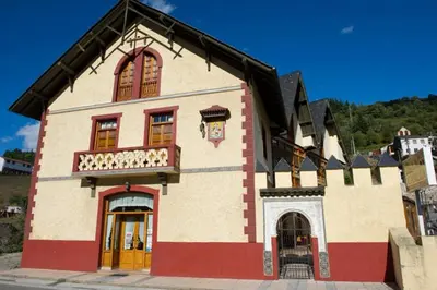 a large building with a red and white at Hotel Restaurante La Casilla in Cangas del Narcea